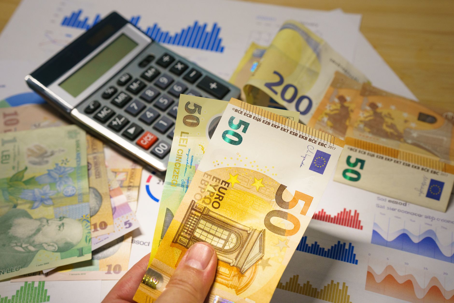 Euro and Romanian Lei currency with calculator on a financial desk setup.
