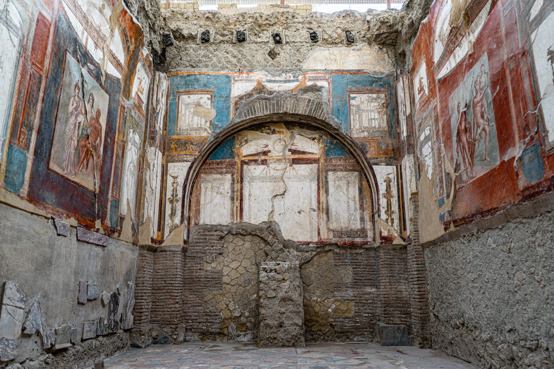 Vivid frescoes adorn the walls of ancient ruins in Ercolano, Italy.