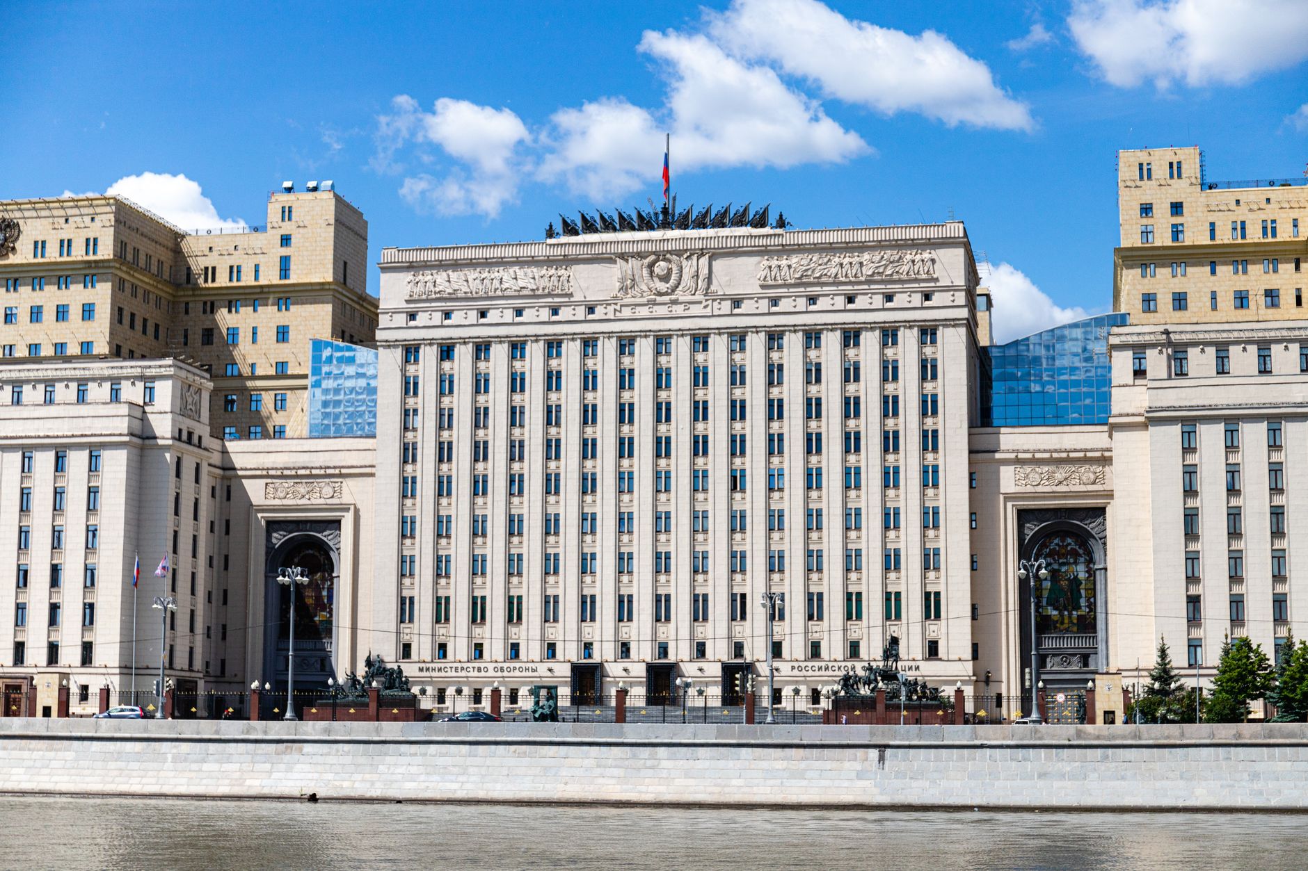 Facade of the Russian Ministry building in Moscow along the river under a clear sky.