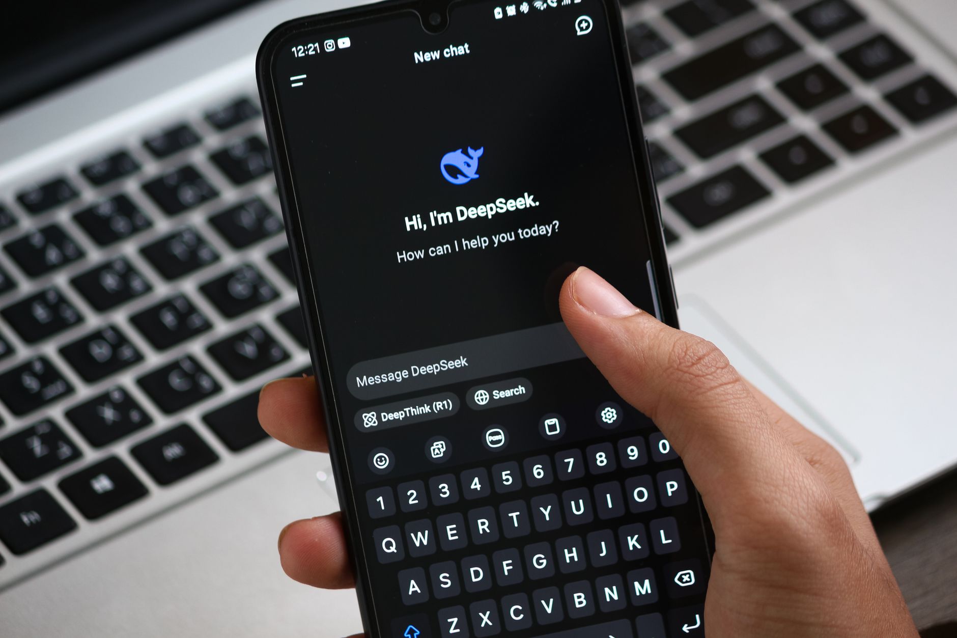 Person interacting with DeepSeek AI chat app on smartphone, focusing on digital innovation and communication.