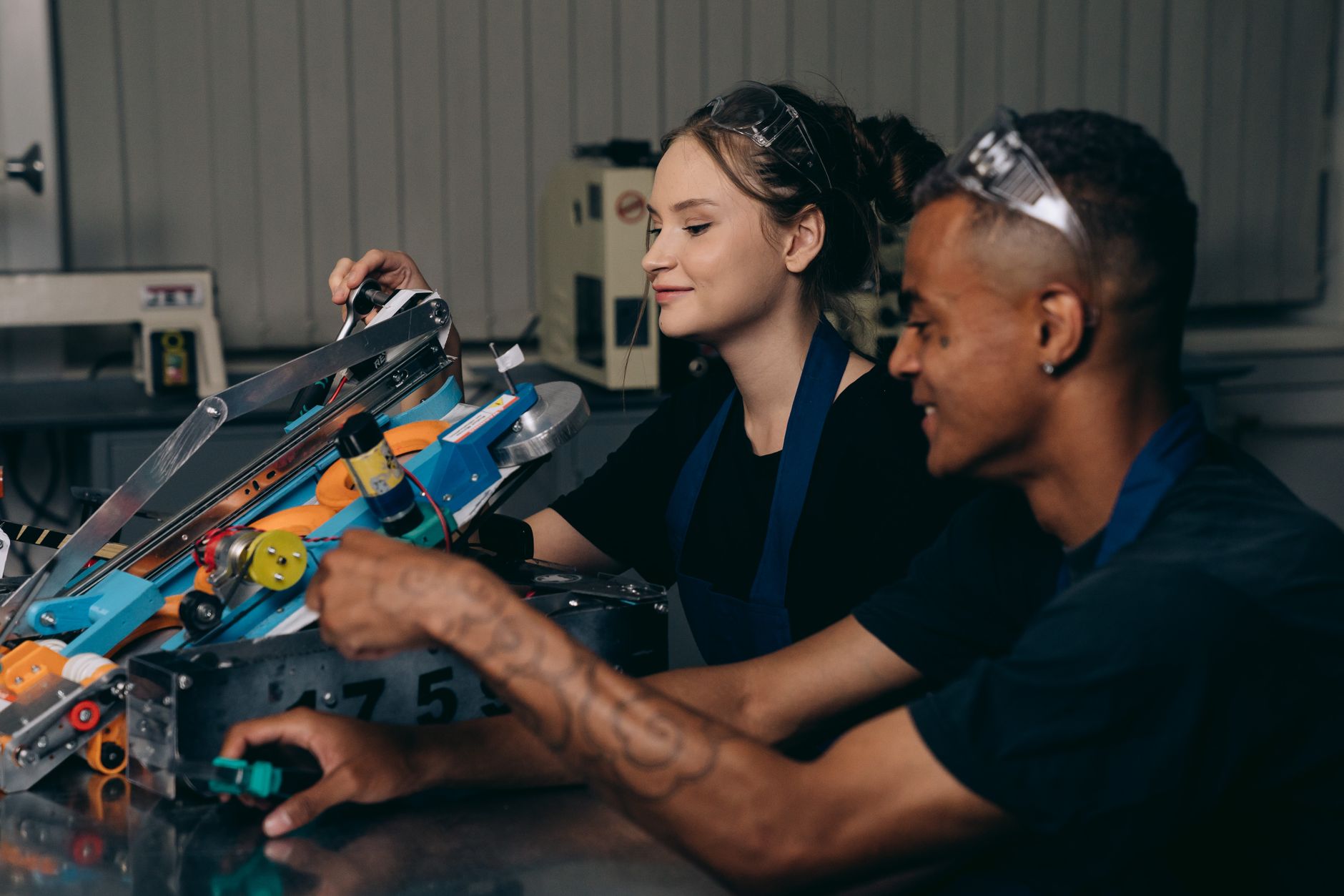 Two engineers working on a robotics project, showcasing teamwork and innovation.